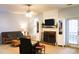 Cozy living room features a ceiling fan, TV, fireplace and comfortable seating arrangement at 912 Tanners Point Dr, Lawrenceville, GA 30044
