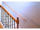 View of a staircase with wood handrail and black iron balusters at 912 Tanners Point Dr, Lawrenceville, GA 30044