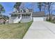 Charming home featuring a welcoming front porch, well-maintained lawn, and attached two-car garage at 1001 Pine Ridge Dr, Stone Mountain, GA 30087