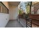 Cozy outdoor back porch features metal railing and mature trees, creating a private retreat at 281 15Th Ne St # 101, Atlanta, GA 30309