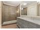 Modern bathroom featuring a glass-enclosed shower, double vanity, and elegant fixtures at 281 15Th Ne St # 101, Atlanta, GA 30309