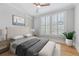 Light-filled bedroom with hardwood floors, neutral paint, plantation shutters, and comfortable furnishings at 281 15Th Ne St # 101, Atlanta, GA 30309
