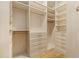 Bright walk-in closet with custom shelving, drawers, and hanging rods offers ample storage space at 281 15Th Ne St # 101, Atlanta, GA 30309