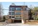 Contemporary building with a brick facade, large windows, and covered parking with street access at 281 15Th Ne St # 101, Atlanta, GA 30309