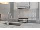 Close-up of the modern kitchen with stainless steel appliances and gray cabinetry at 281 15Th Ne St # 101, Atlanta, GA 30309