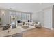 Cozy living area with ample natural light, hardwood floors, a comfortable sofa, and access to the outdoors at 281 15Th Ne St # 101, Atlanta, GA 30309