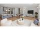 Open-concept living room featuring hardwood floors, modern decor, kitchen, and adjacent dining area at 281 15Th Ne St # 101, Atlanta, GA 30309