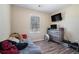 Bedroom with wood-look flooring, natural light, dresser, and a wall mounted television at 1143 Forest Villa Nw Dr, Conyers, GA 30012