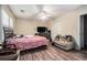 Bedroom with wood-look flooring, a ceiling fan, natural light and casual seating at 1143 Forest Villa Nw Dr, Conyers, GA 30012