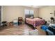 Bedroom with wood-look flooring, natural light and a bed with a colorful paisley patterned coverlet at 1143 Forest Villa Nw Dr, Conyers, GA 30012