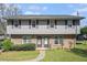 Traditional two-story duplex featuring brick facade and neutral siding at 1143 Forest Villa Nw Dr, Conyers, GA 30012