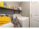 Laundry room with shelving above the washing machine at 1143 Forest Villa Nw Dr, Conyers, GA 30012