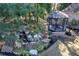 Serene backyard featuring a waterfall, lush landscaping, and a gazebo at 2160 Kensington Gates Nw Dr, Kennesaw, GA 30152