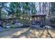 Secluded backyard with gazebo, a lush garden featuring a waterfall, and mature trees creating a private outdoor space at 2160 Kensington Gates Nw Dr, Kennesaw, GA 30152