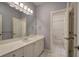 Bright bathroom featuring a long white vanity and tile flooring at 2160 Kensington Gates Nw Dr, Kennesaw, GA 30152