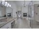Bright bathroom with a fireplace, soaking tub, and glass shower at 2160 Kensington Gates Nw Dr, Kennesaw, GA 30152