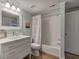 Bathroom featuring white vanity, framed mirror, and a shower-tub combination with a decorative shower curtain at 2160 Kensington Gates Nw Dr, Kennesaw, GA 30152