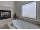 Bright bathroom with a soaking tub and fireplace at 2160 Kensington Gates Nw Dr, Kennesaw, GA 30152
