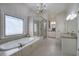 Bright bathroom with a soaking tub, granite counters, and a glass enclosed shower at 2160 Kensington Gates Nw Dr, Kennesaw, GA 30152