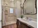 Elegant bathroom with a marble vanity, tiled shower with a rainfall showerhead, and stylish fixtures at 2160 Kensington Gates Nw Dr, Kennesaw, GA 30152