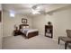 Bedroom with a wooden bed frame, neutral carpet, and a view of a globe and bookcase at 2160 Kensington Gates Nw Dr, Kennesaw, GA 30152