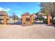 Elegant community entrance featuring brick pillars, wrought iron gates, and manicured landscaping at 2160 Kensington Gates Nw Dr, Kennesaw, GA 30152