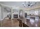 Open dining area with hardwood floors, fireplace, modern lighting, and a view of the kitchen at 2160 Kensington Gates Nw Dr, Kennesaw, GA 30152