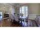 Dining room with chandelier, large window, and hardwood floors, open to the foyer at 2160 Kensington Gates Nw Dr, Kennesaw, GA 30152