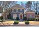 Charming two-story home featuring a unique gray stucco and brick exterior with a beautifully landscaped front yard at 2160 Kensington Gates Nw Dr, Kennesaw, GA 30152