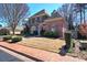 A well-maintained front yard, a manicured lawn, and a classic brick walkway enhance the curb appeal of this home at 2160 Kensington Gates Nw Dr, Kennesaw, GA 30152