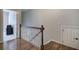 Hallway with hardwood flooring, white banister, and access to additional rooms and storage space at 2160 Kensington Gates Nw Dr, Kennesaw, GA 30152
