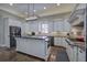 Spacious kitchen with stainless steel appliances, granite countertops, a center island, and custom white cabinets at 2160 Kensington Gates Nw Dr, Kennesaw, GA 30152