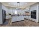 Well-equipped kitchen with a center island, stainless steel appliances, custom white cabinets, and hardwood floors at 2160 Kensington Gates Nw Dr, Kennesaw, GA 30152