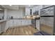 Well-equipped kitchen with stainless steel appliances, granite countertops, white cabinetry, and hardwood floors at 2160 Kensington Gates Nw Dr, Kennesaw, GA 30152