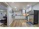 Modern kitchen featuring white cabinets, stainless steel appliances, granite countertops, and hardwood flooring at 2160 Kensington Gates Nw Dr, Kennesaw, GA 30152