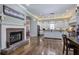 Spacious kitchen with brick fireplace, hardwood floors, white cabinets, and modern appliances at 2160 Kensington Gates Nw Dr, Kennesaw, GA 30152
