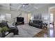 Comfortable living room with coffered ceilings, hardwood floors, and staircase access at 2160 Kensington Gates Nw Dr, Kennesaw, GA 30152