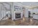 Spacious open living area with hardwood floors, fireplace, and access to the kitchen at 2160 Kensington Gates Nw Dr, Kennesaw, GA 30152