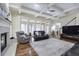 Spacious living room with coffered ceilings, fireplace, and hardwood floors and large windows providing ample natural light at 2160 Kensington Gates Nw Dr, Kennesaw, GA 30152