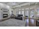 Spacious living room featuring a fireplace, hardwood floors, and coffered ceilings at 2160 Kensington Gates Nw Dr, Kennesaw, GA 30152