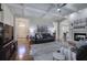 Bright living room featuring hardwood floors, fireplace, and an open layout leading to the foyer and kitchen at 2160 Kensington Gates Nw Dr, Kennesaw, GA 30152
