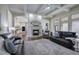 Open living room with fireplace, coffered ceiling, and seamless flow to the kitchen at 2160 Kensington Gates Nw Dr, Kennesaw, GA 30152