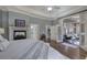 Serene main bedroom features a fireplace, tray ceilings, and French doors opening to a sunroom at 2160 Kensington Gates Nw Dr, Kennesaw, GA 30152