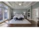 Bright main bedroom features trey ceiling, hardwood floors, a fireplace and large windows at 2160 Kensington Gates Nw Dr, Kennesaw, GA 30152