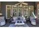 This light-filled screened porch features neutral furnishings and views of the surrounding greenery at 2160 Kensington Gates Nw Dr, Kennesaw, GA 30152