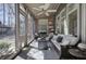 Bright and airy sunroom features a ceiling fan, comfortable seating, and views of the outdoor gazebo at 2160 Kensington Gates Nw Dr, Kennesaw, GA 30152