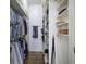 Organized walk-in closet with custom shelving and hardwood floors at 2160 Kensington Gates Nw Dr, Kennesaw, GA 30152