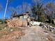 Damaged home exterior with debris scattered across the yard and driveway, in need of complete restoration or demolition at 3440 Corral Dr, Marietta, GA 30066