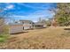 Expansive backyard view featuring a shed and screened-in porch, perfect for relaxation at 3679 Mill Glen Dr, Douglasville, GA 30135