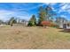 Large backyard with a mix of trees and grass on a sunny day at 3679 Mill Glen Dr, Douglasville, GA 30135